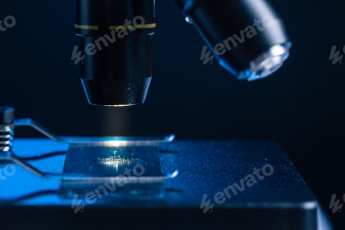Preview: Microscope with lenses close up against dark background