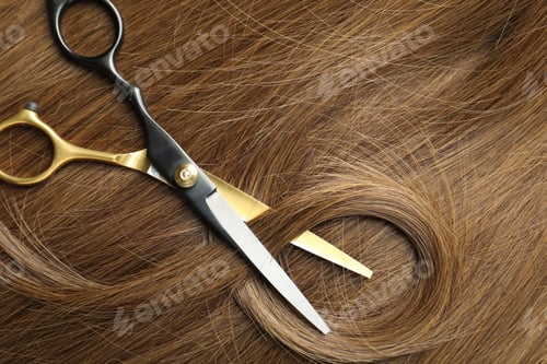 Preview: Scissors with lock of beautiful brown hair, top view