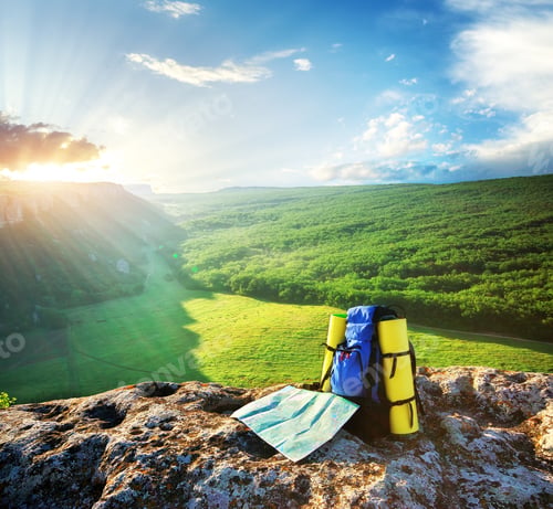 Scenic Mountain Vista with Backpack and Map