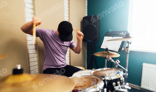 Preview: A man expressively plays the drum kit. Playing musical instruments.
