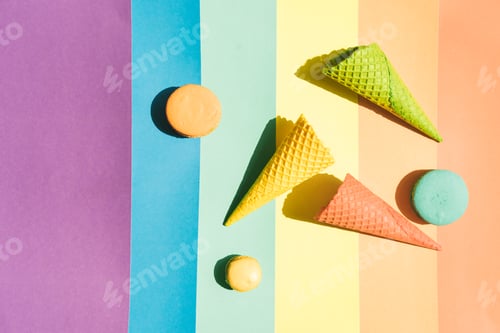Preview: Waffle cones for ice cream and macaroons on a rainbow background