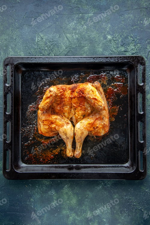 Preview: top view delicious baked chicken with spices on a dark-blue background spicy pepper meat bird dish