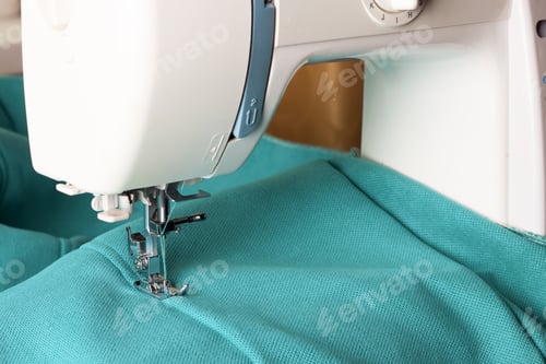 Preview: Modern sewing machine and turquoise fabric