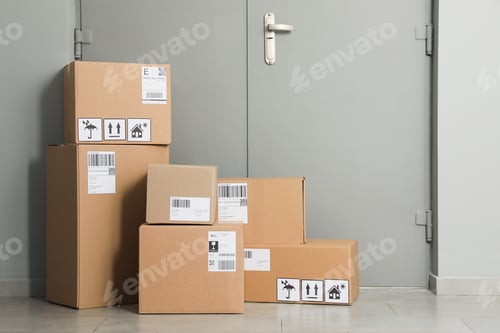 Preview: Cardboard boxes on floor near entrance. Parcel delivery service