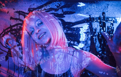 Preview: positive facial expression. Stylish woman with white hair is behind wet transparent plastic sheet