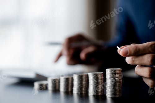 Preview: Business man putting a coin on a pile of coins.