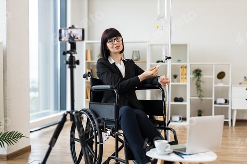 Preview: Businesswoman recording blog about work and health while receiving treatment