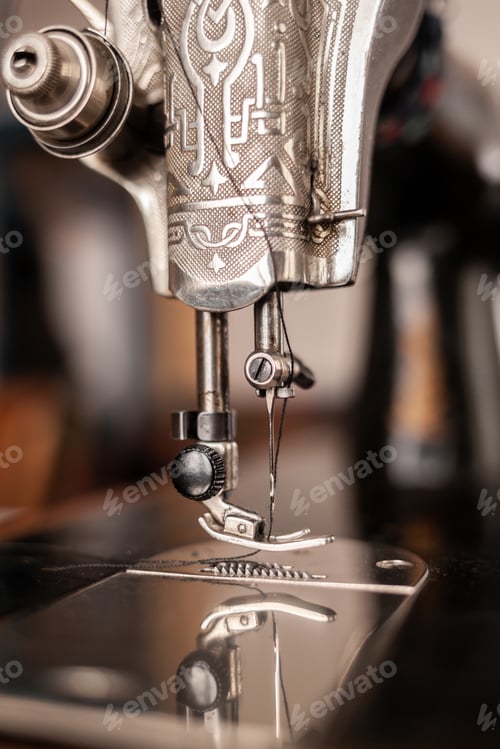 Preview: Old sewing machine stands on the table at home ready to work and sew.