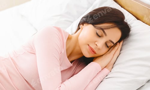 Preview: Woman Laying in Bed With Head on Pillow
