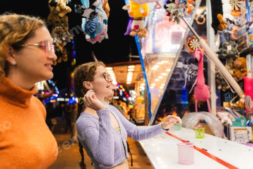 Preview: Friends playing fair games enjoying evening entertainment