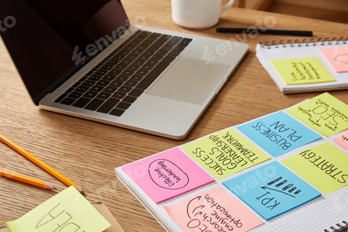 Preview: paper stickers with business strategy and laptop on wooden tabletop