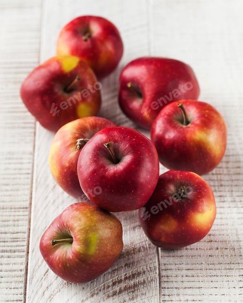 Preview: Ripe juicy red apples on a wooden white background. Harvesting.