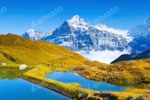 Preview: Grindelwald, Switzerland. High mountains and reflection on the surface of the lake.