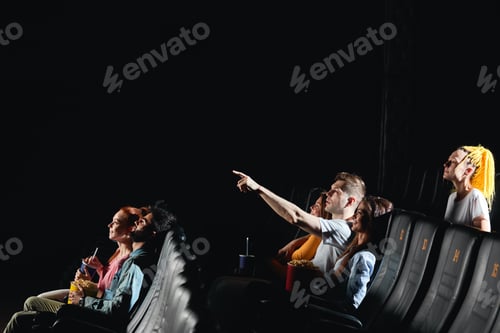 Preview: young man pointing to the screen, he has noticed detail, simbol of the film