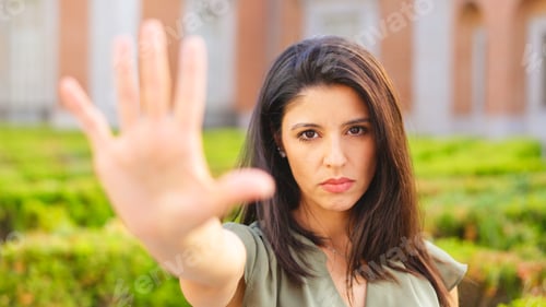 Preview: Woman gesturing stop with the hand with serious expression