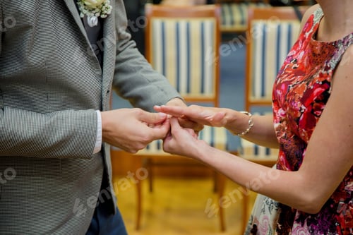 Preview: Male putting an engagement ring on the hand of a female