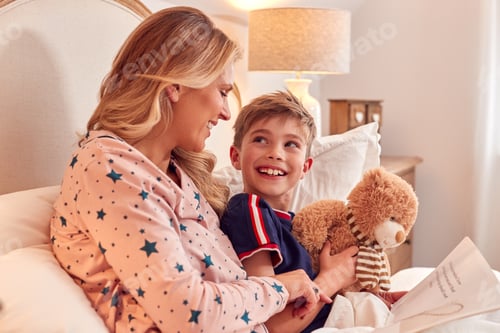 Preview: Mother And Son In Bed At Home Reading Story Together