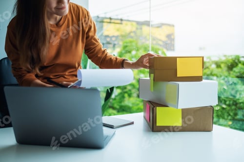 Preview: Entrepreneur checking orders from customer for online shopping and delivery concept