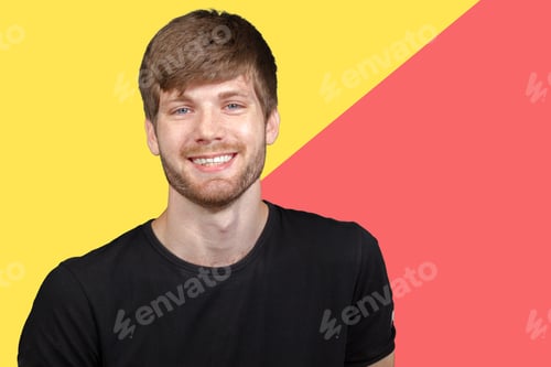Preview: Young man smiling confidently against a colorful background in a studio setting