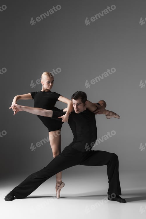 Preview: two young modern ballet dancers on gray studio background