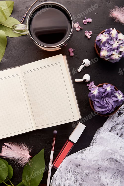 Preview: Open notebook mockup top view. Coffee time, purple floral cupcakes, cup of coffee near cosmetics