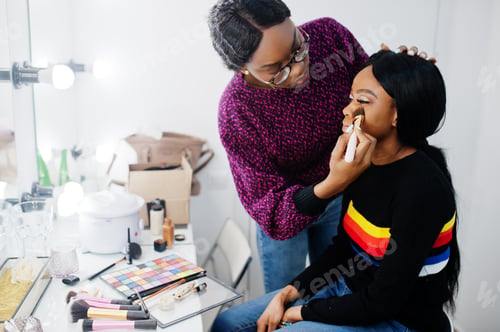 Preview: African American woman applying make-up