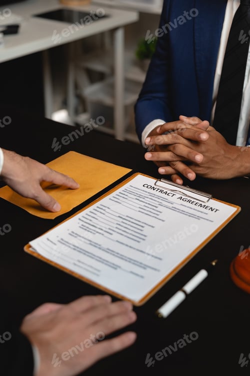 Preview: Businessman hands money envelope to lawyer in bribe over illegal business contract documents Investi