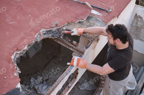 Preview: Young man tearing the roof of a house down.