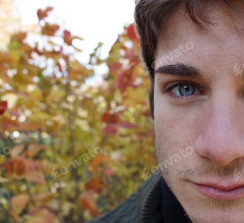Close-up of Young Man's Face in Autumn Setting