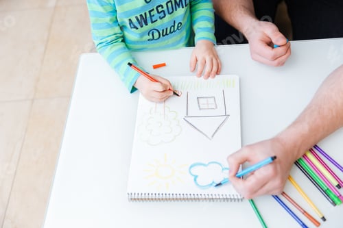 Preview: Hands of little son and father drawing with colorful markers