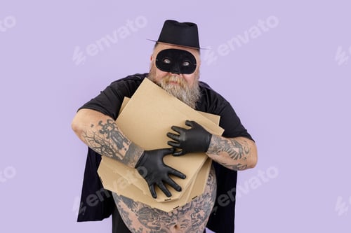 Preview: Man in Zorro costume with overweight hugs brown boxes of pizza on purple background