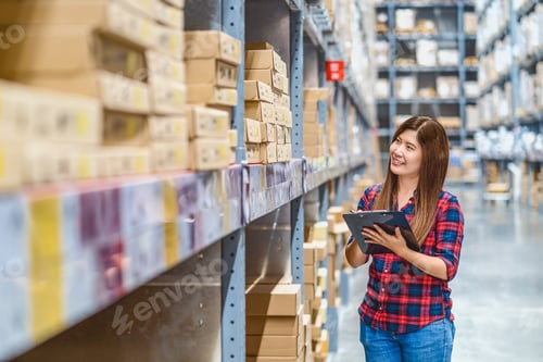 Preview: Asian woman warehouse worker standing and checking goods stock in warehouse