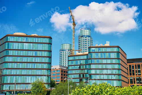 Preview: Construction crane building new office buildings in modern business district