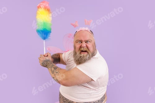 Preview: Funny angry plump man in fairy suit attacks with brush on purple background