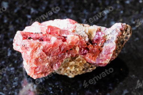 Preview: sample of rough rhodonite rock on black