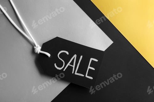 Preview: Tag with word SALE on color background, top view. Black Friday concept