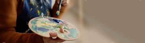 Preview: Header of Caucasian Woman Painting with Palette during Art Education Class