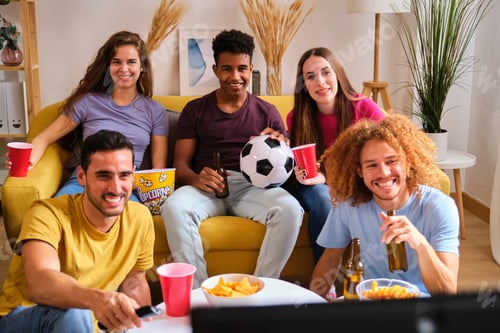Preview: Happy young friends watching sports on TV.