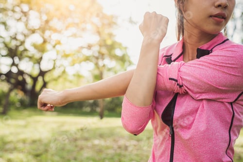 Preview: Asian young woman warm up the body stretching before morning exercise and yoga in the park.