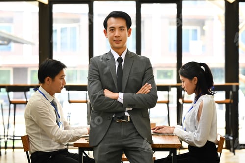 Preview: Portrait of confident asian male executive in suit standing with crossed arms.