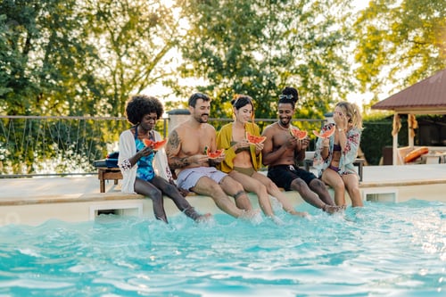 Preview: Friends eating watermelon by the poolside during summer vacation