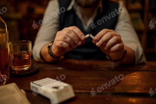 Preview: Man breaks a cigarette, bad habit and addiction