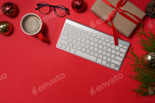 Preview: Coffee cup, keyboard and gifts boxes on red background.