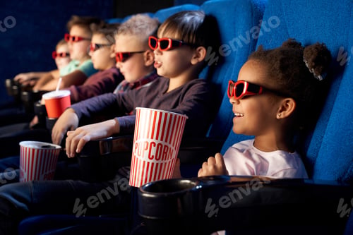 Preview: African girl wearing 3d eyeglasses in cinema
