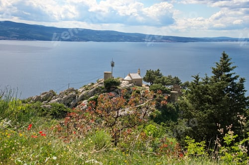 Preview: Little medieval stone church in Croatia on the cliff above Adriatic sea