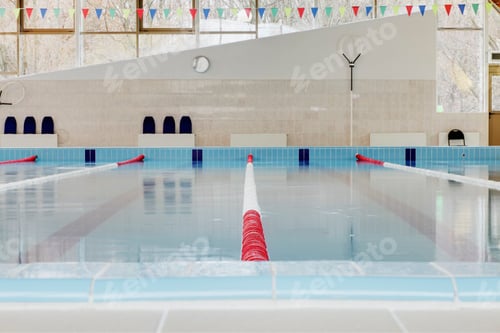 Preview: Indoor swimming pool, red and white dividers in swim lanes, surface view.