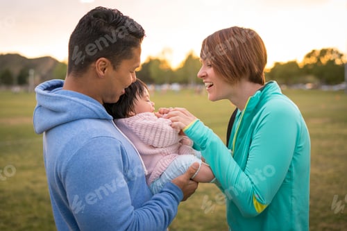 Preview: Couple playing with baby in park