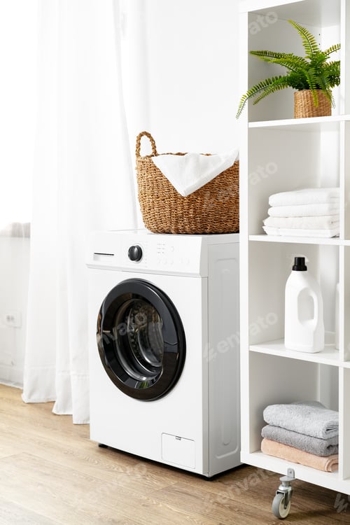 Preview: Laundry room with washing machine and basket with laundry