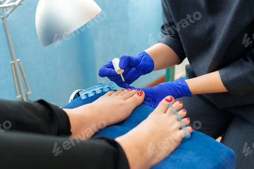 Preview: Person receiving pedicure at a salon during the day with bright blue walls