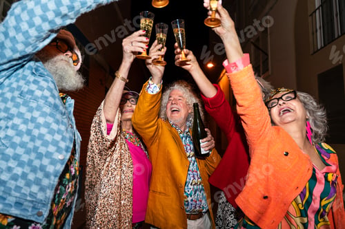 Preview: Group of happy senior friends with fancy clothing having party in the night